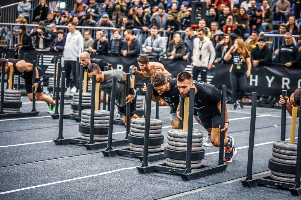 Line of HYROX athletes performing the sled push station